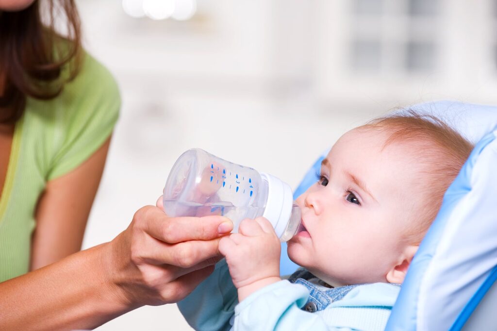 What are the risks of giving water to infants